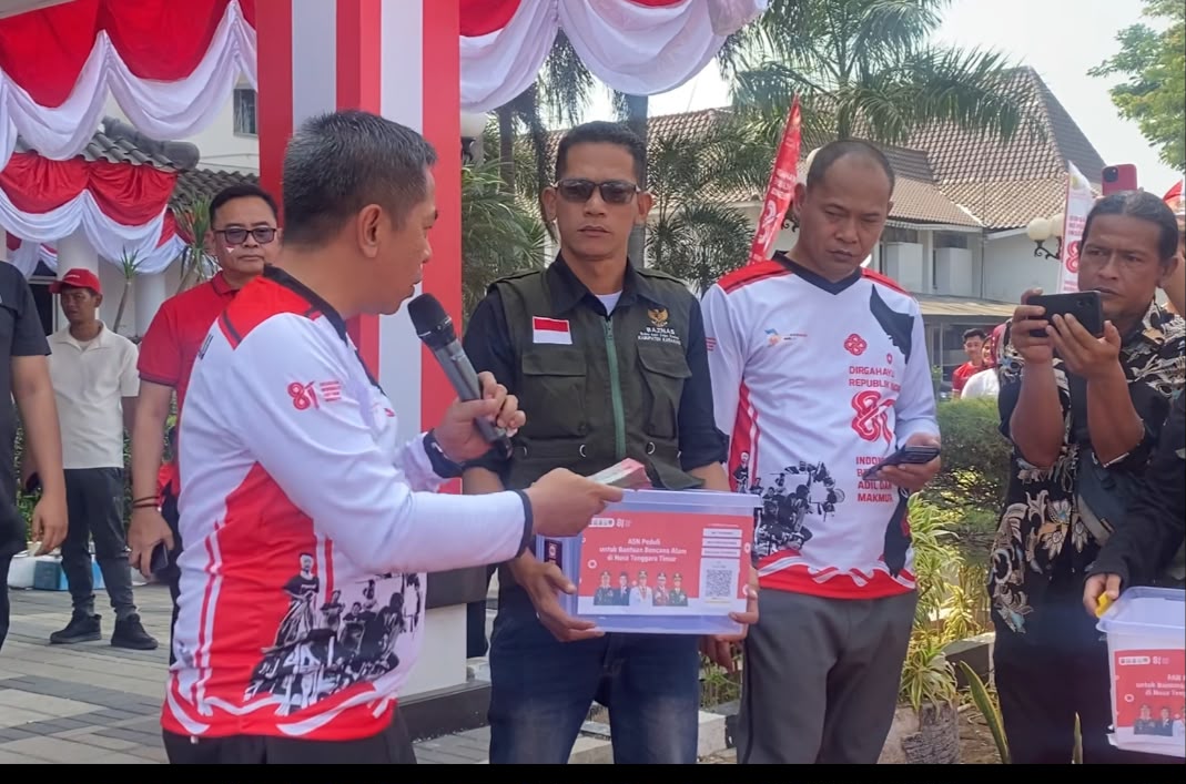 Bupati Karawang Aep Syaepuloh menyerahkan simbolis donasi Rp20 juta untuk korban gempa NTT di Plaza Pemda Karawang saat acara HUT Kemerdekaan RI, didampingi pejabat BAZNAS dan perwakilan ASN.
